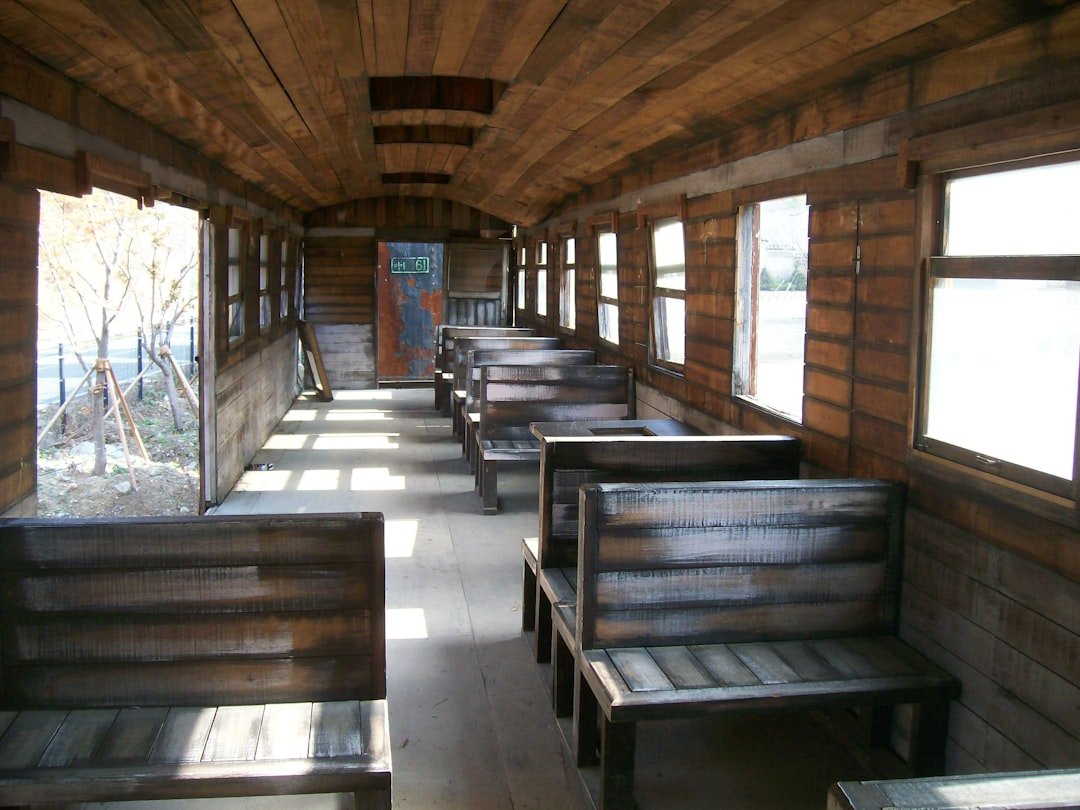 a row of benches sitting inside of a wooden building