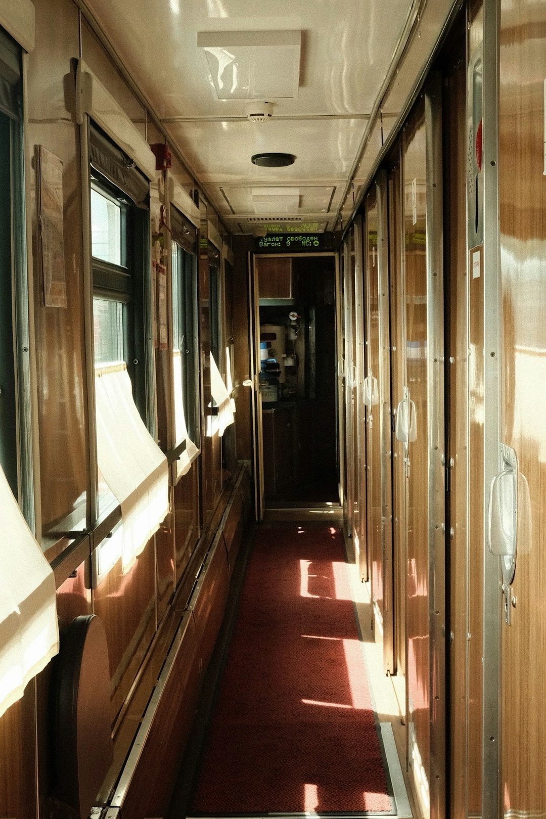 Interior hallway of an old train carriage.