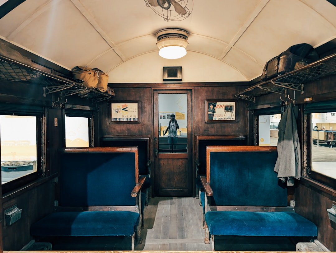 The inside of a train car with blue seats