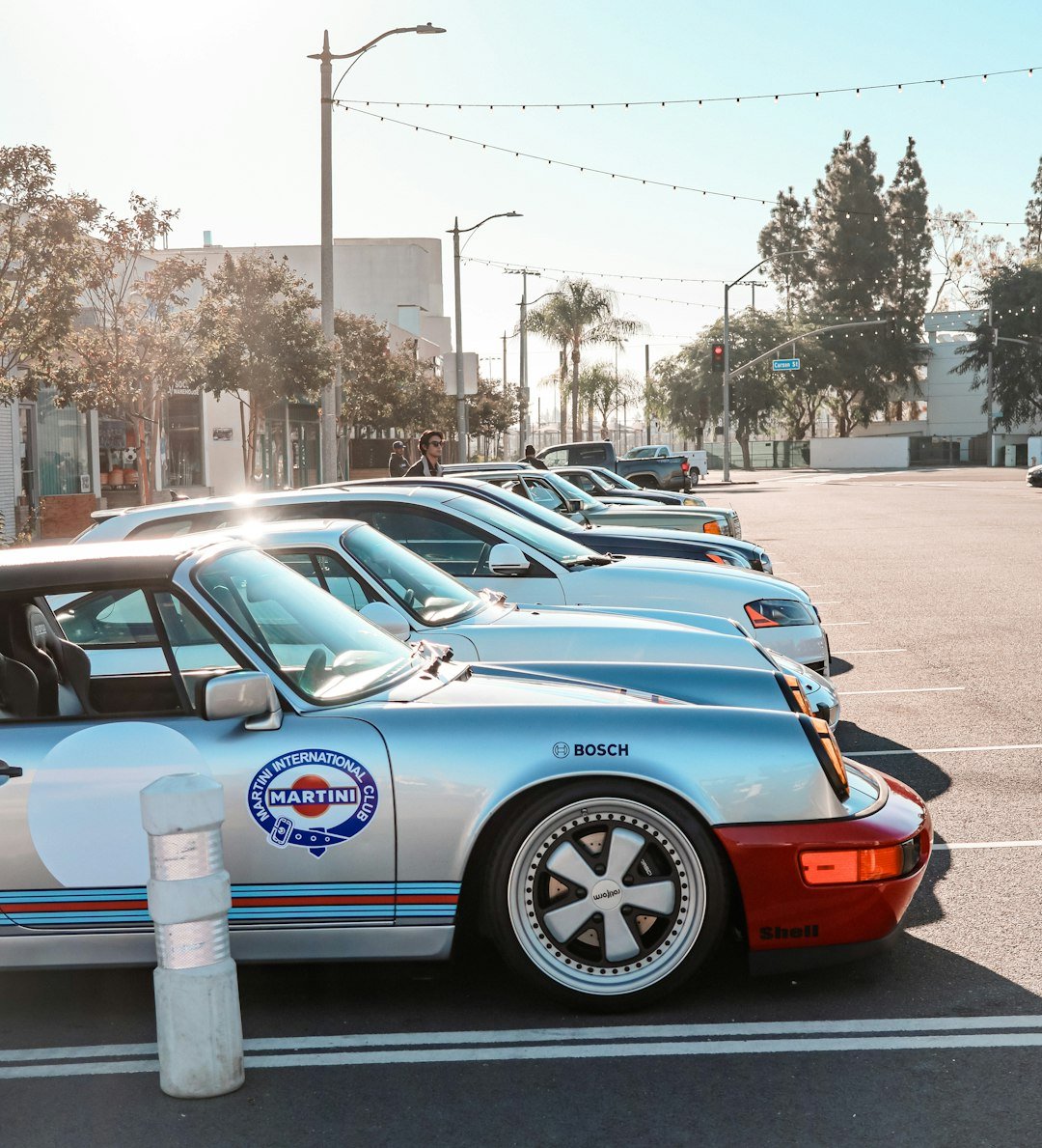 a row of parked cars in a parking lot