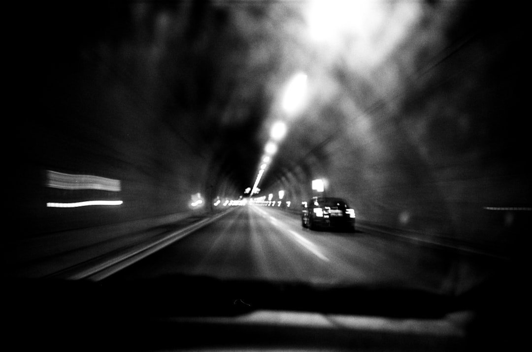 a car driving down a street at night