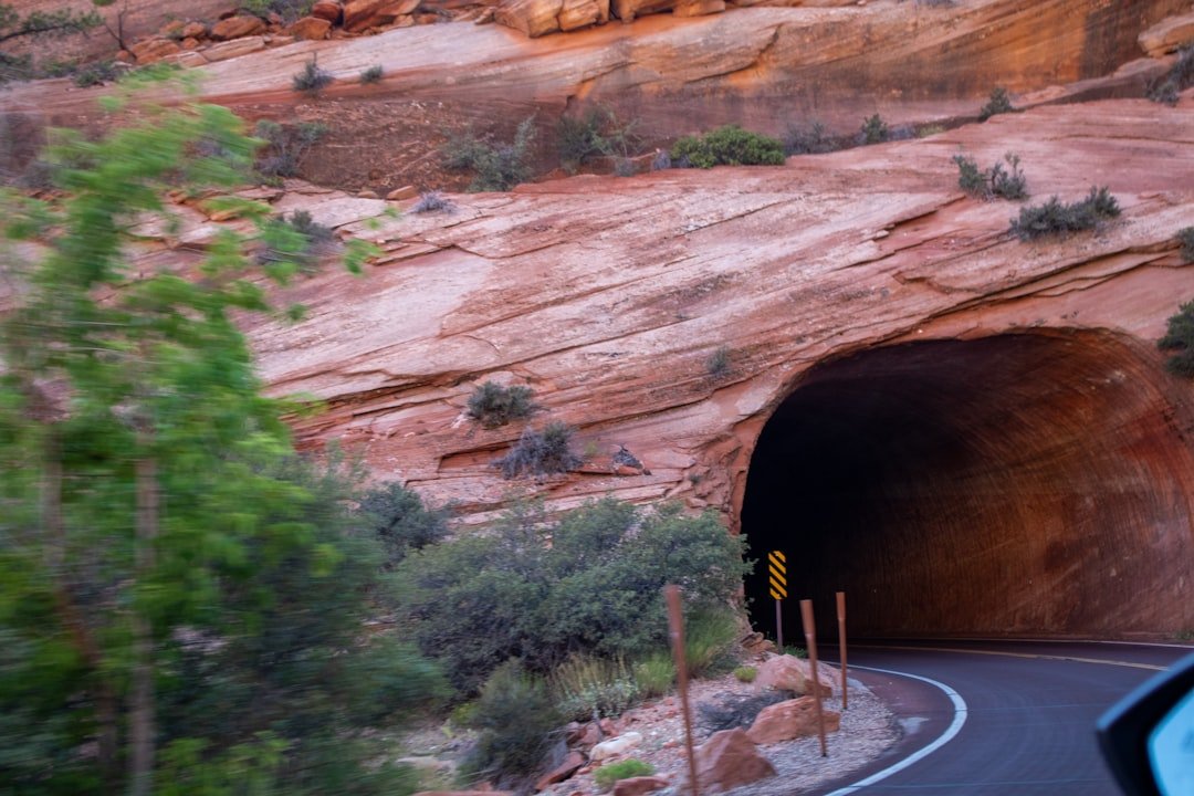 A car driving through a tunnel in the desert