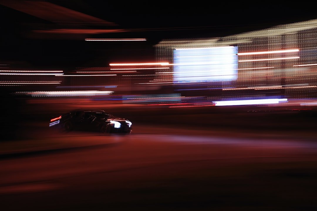 Car speeding through the night with motion blur.