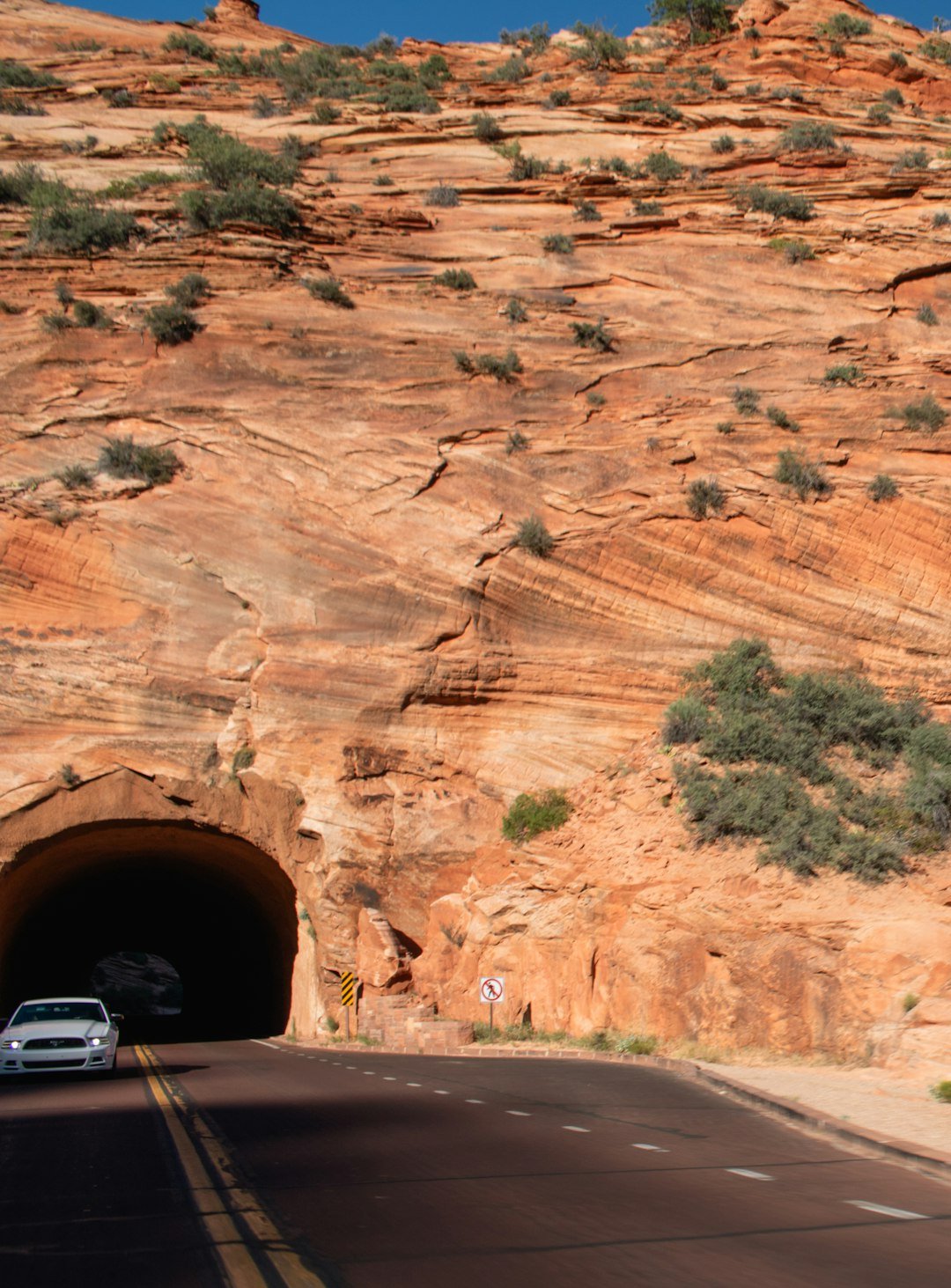 A car driving through a tunnel on a road
