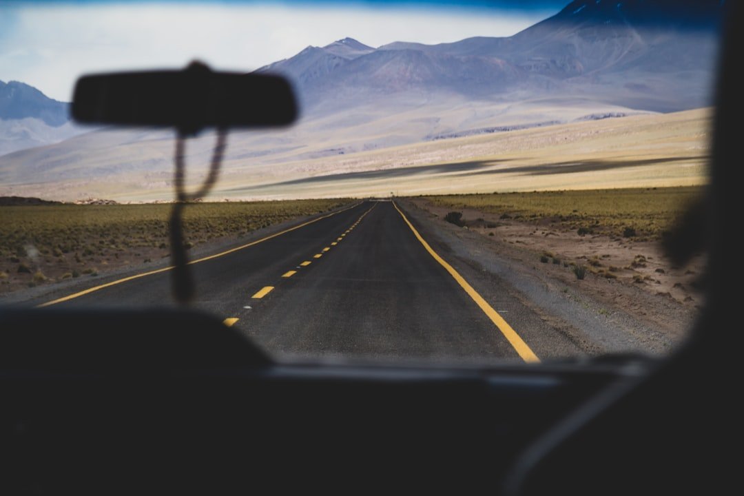 Empty highway stretching towards distant mountains