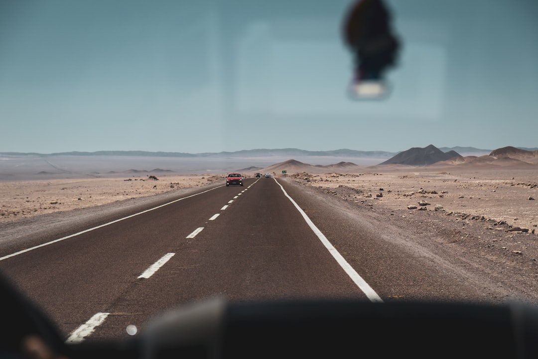 Long desert highway stretching towards distant mountains