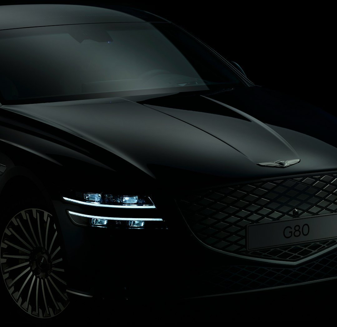 a black car is shown in the dark