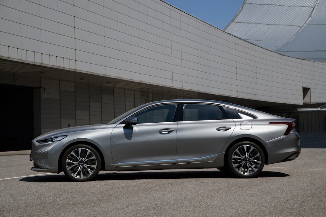 a silver car parked outside a building
