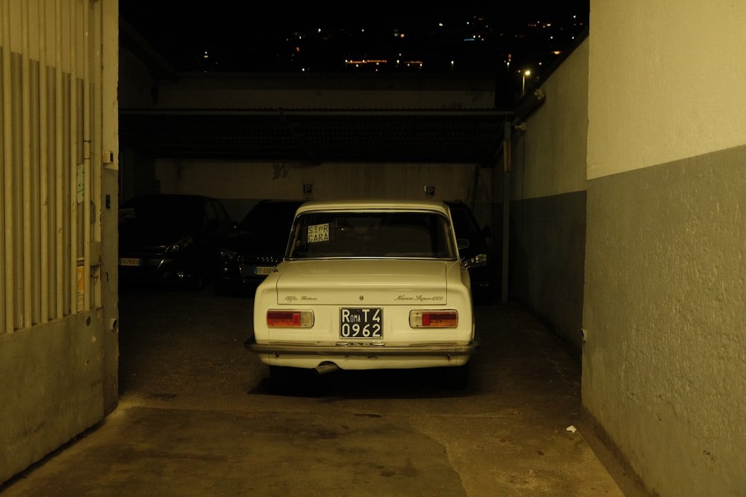 A white car parked in a parking garage