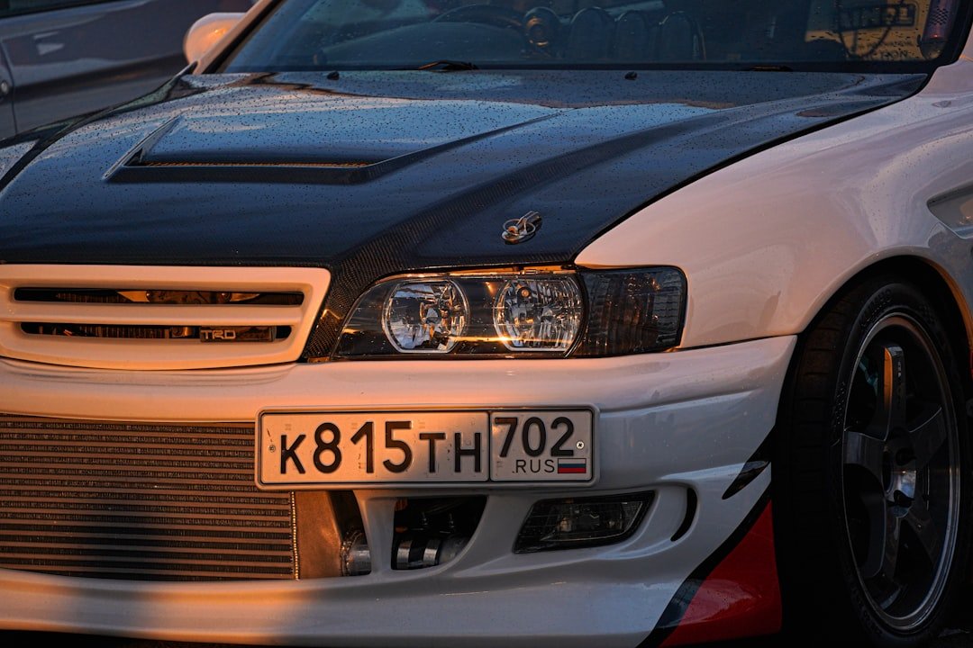 A white car with a black hood.