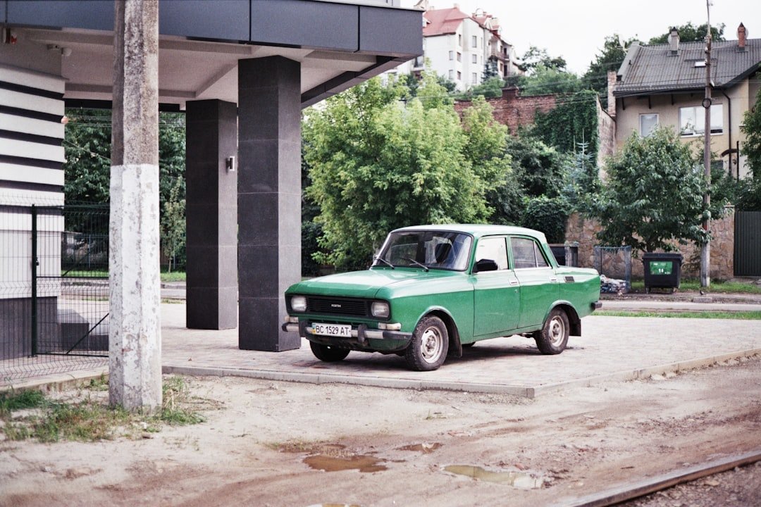 a green truck parked in front of a building