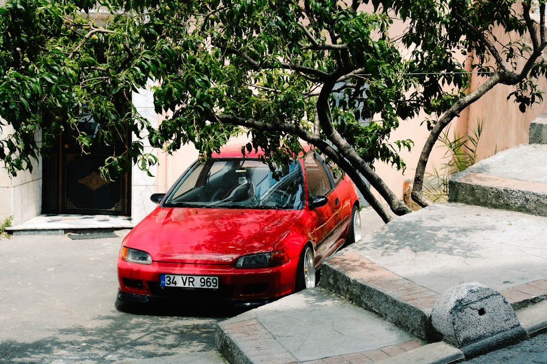 a red car parked on the side of a road