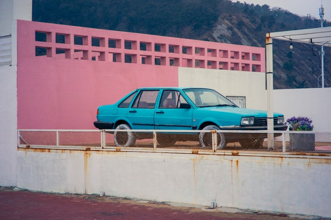 a blue car parked on the side of a road