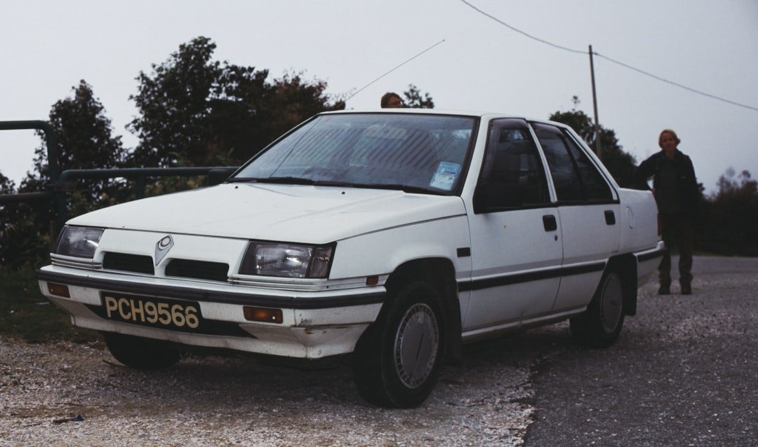 A white car parked on the side of a road