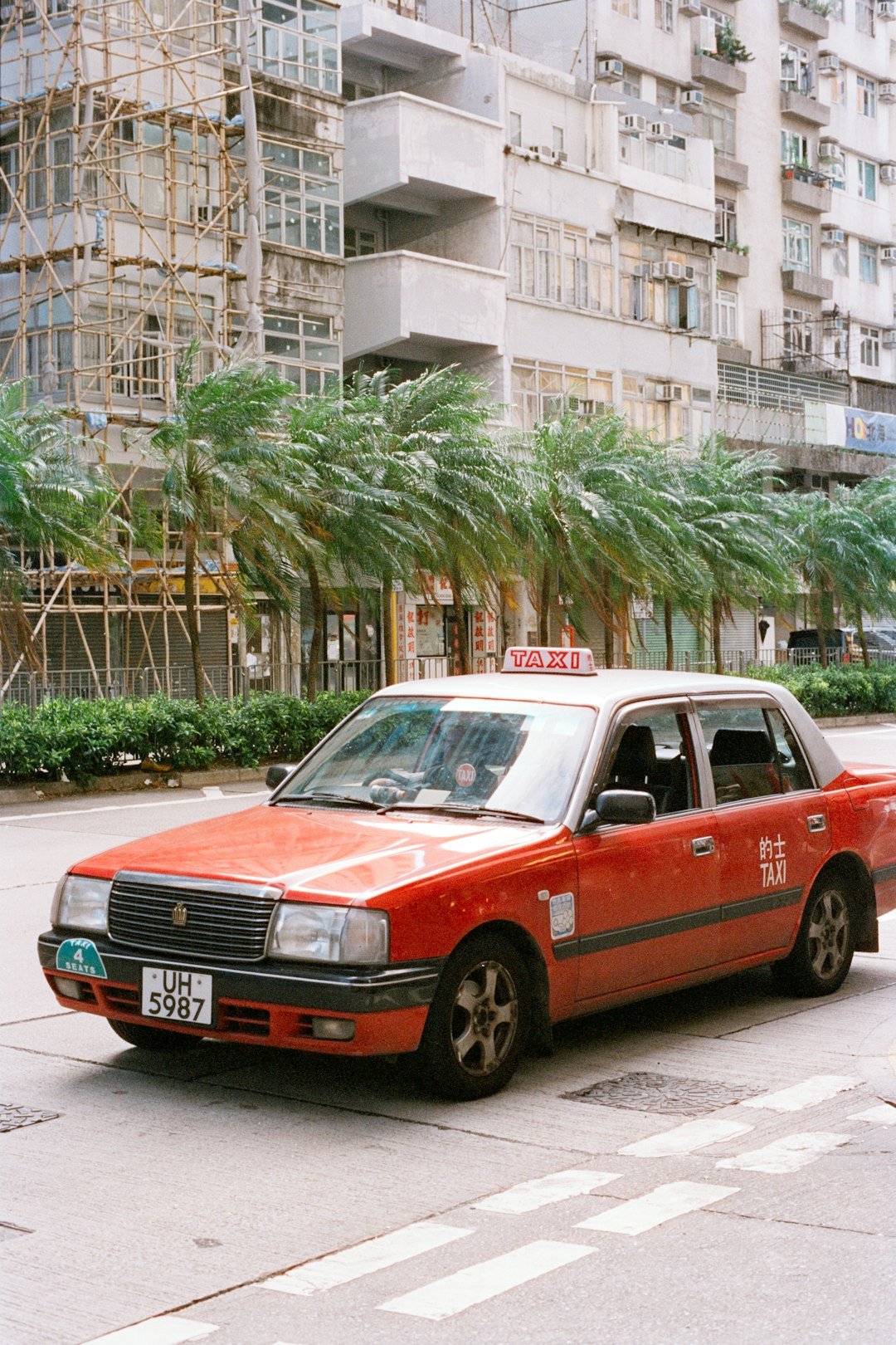 Red taxi parked on a city street