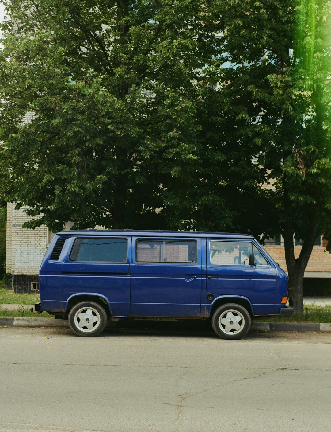 a blue van parked on the side of the road