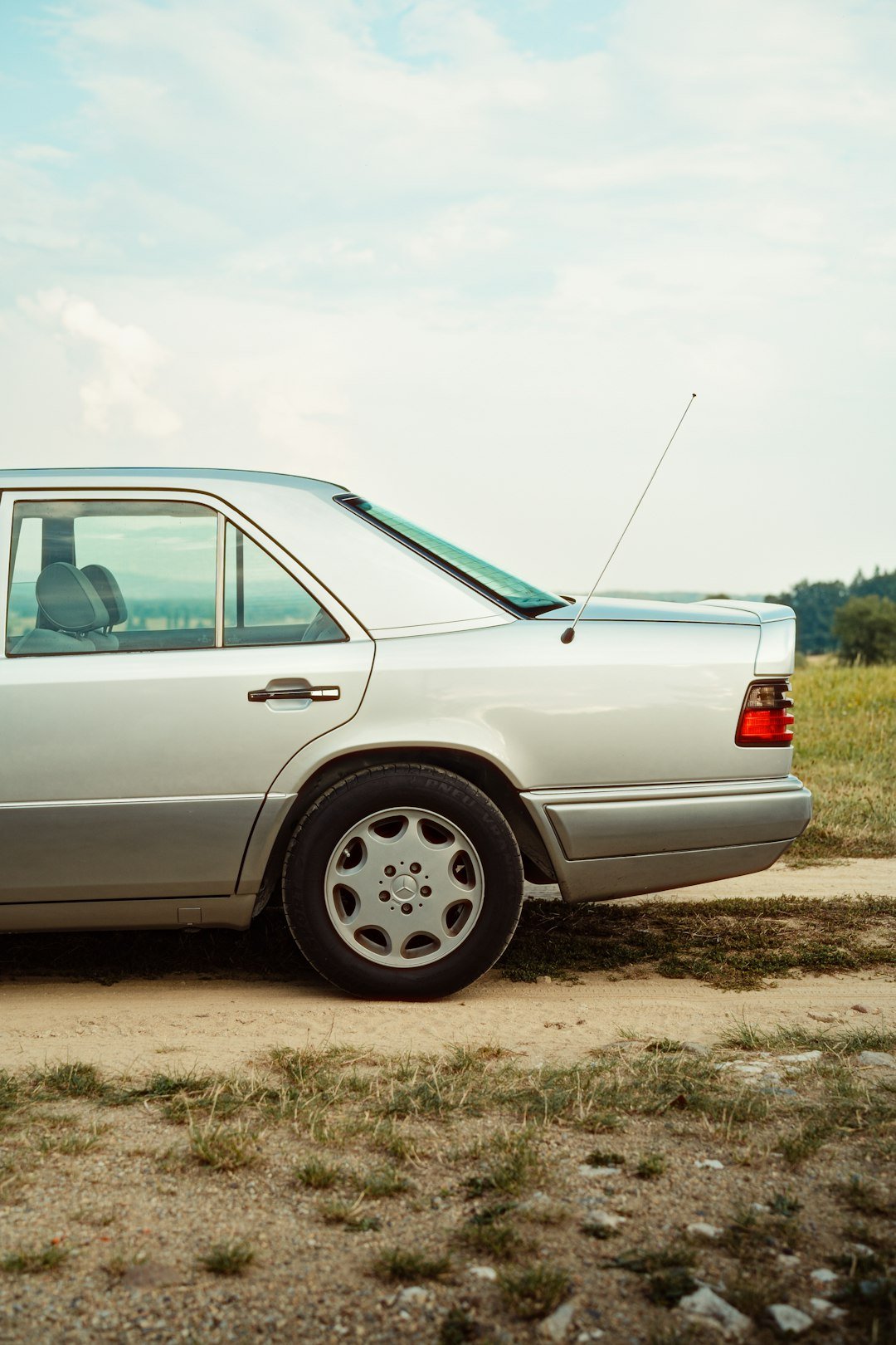 A silver car parked on the side of the road