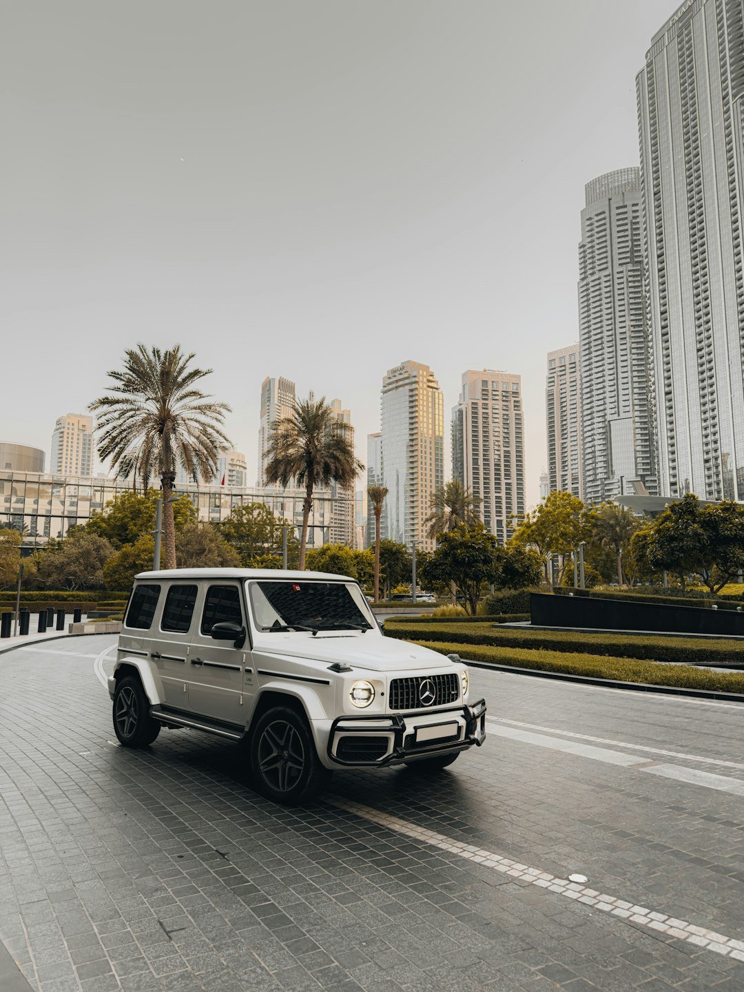 Silver luxury suv driving on a city street.