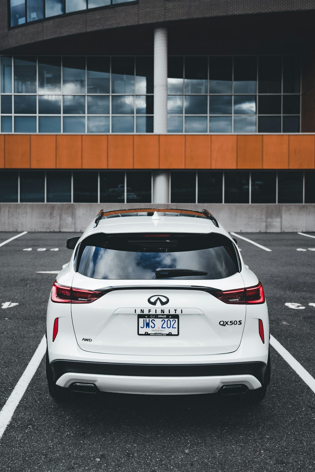 White infiniti suv parked in a lot