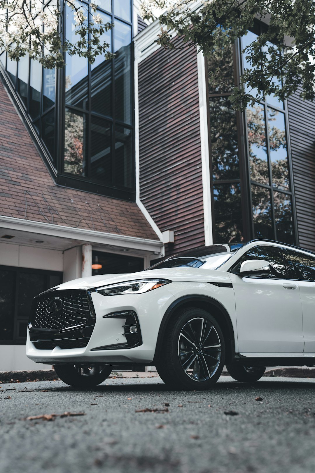 White suv parked in front of modern building