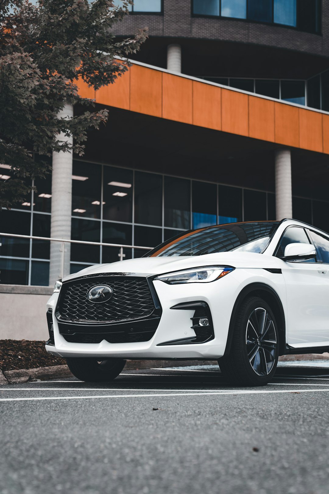 White luxury suv parked in front of modern building