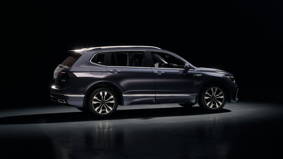 Dark blue suv parked on a reflective surface.