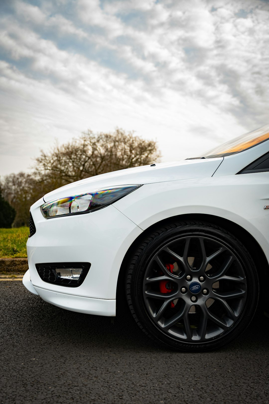 A white car with a focus on its front.
