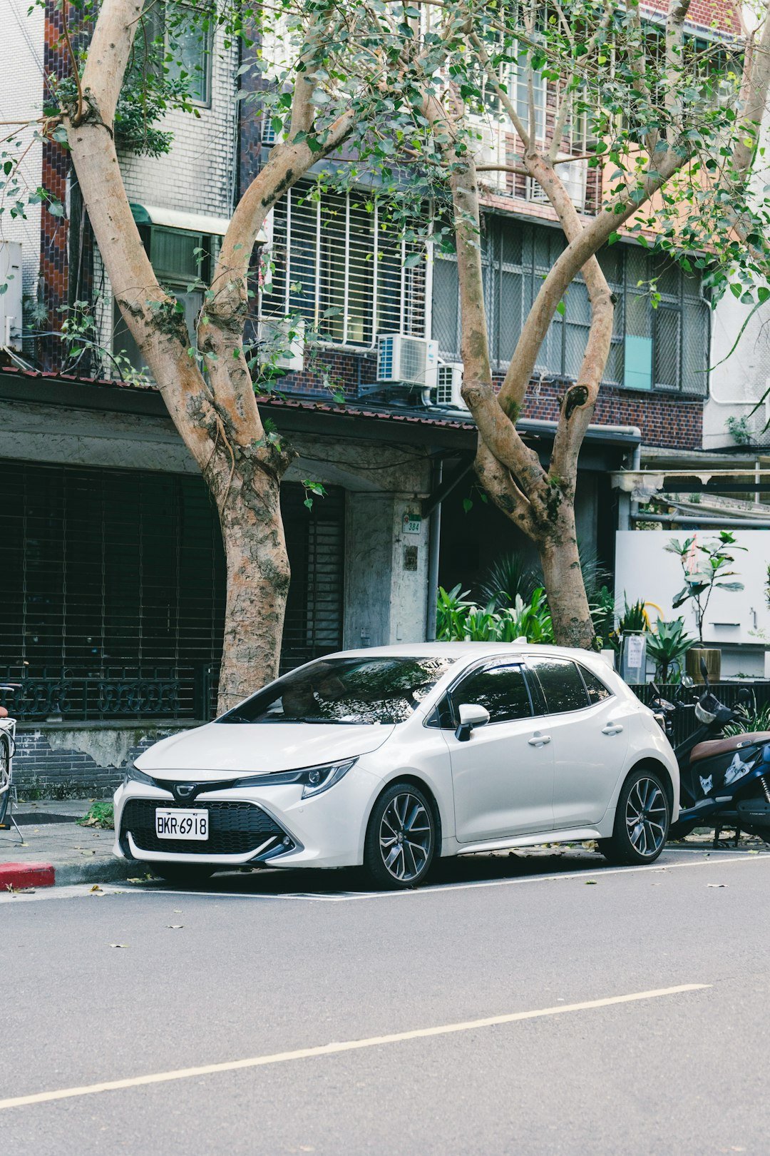 A white car parked on a city street.