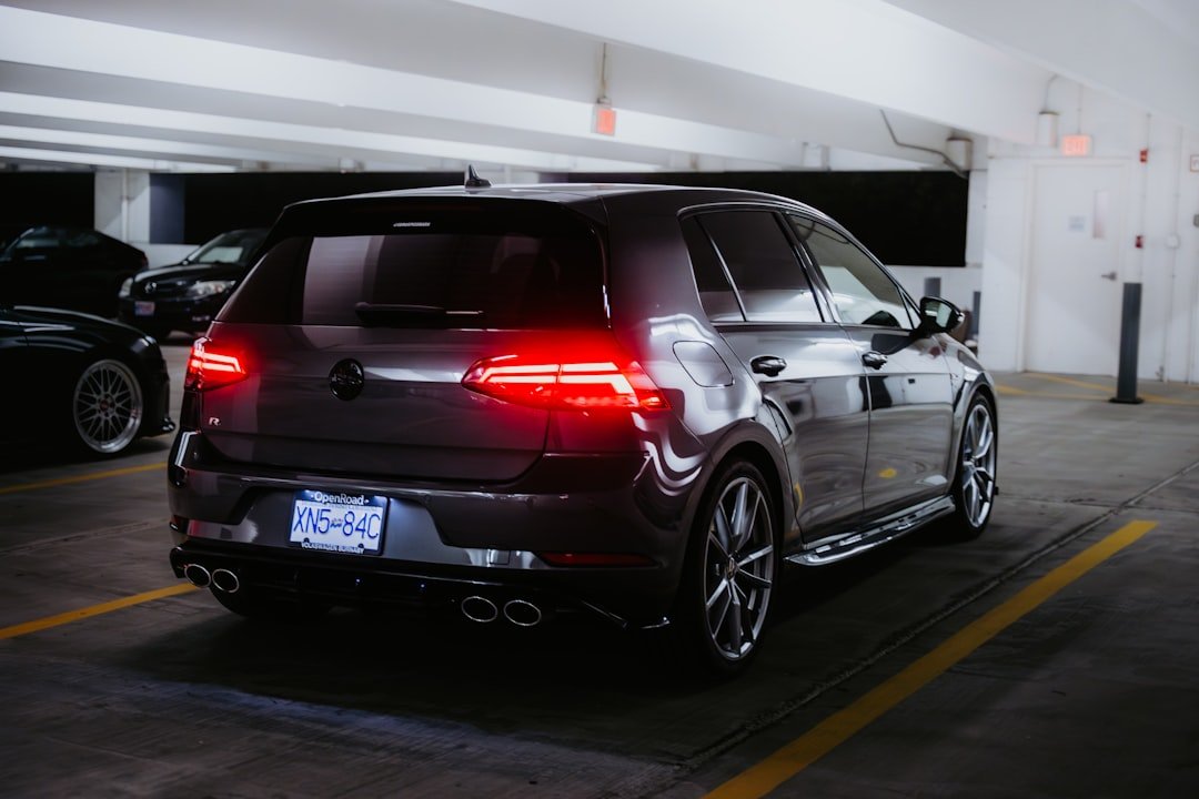 Dark hatchback car parked in a garage.