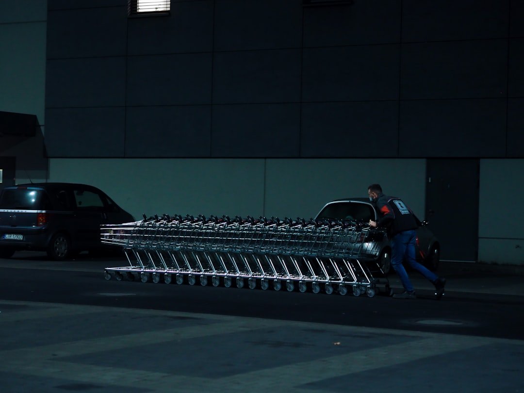 a man pushing a cart full of luggage down a street