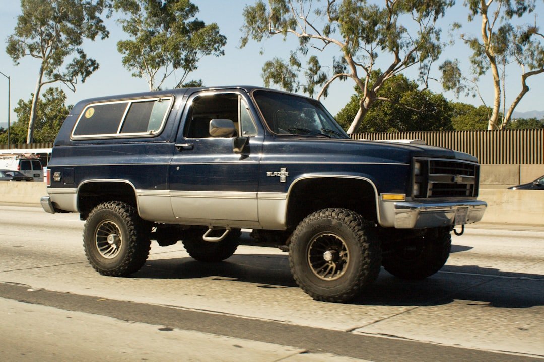 Dark blue vintage suv driving on a highway