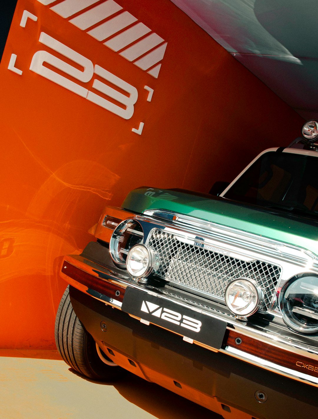 Green vehicle with chrome grille and headlights