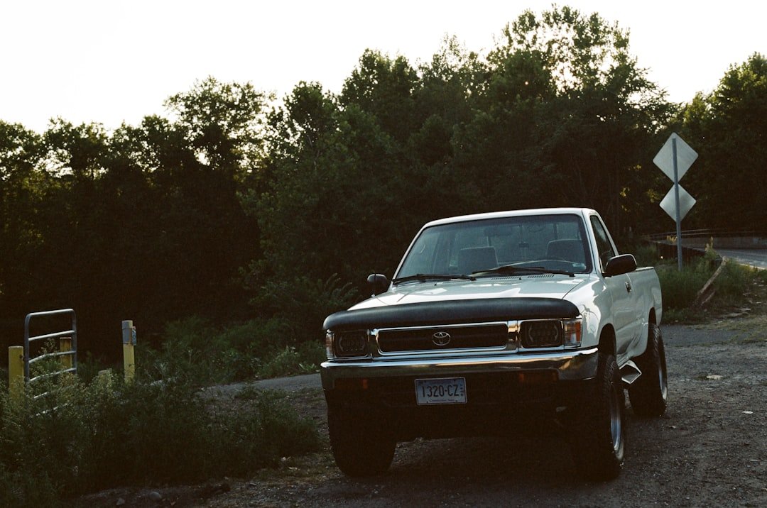 White pickup truck parked on a dirt road