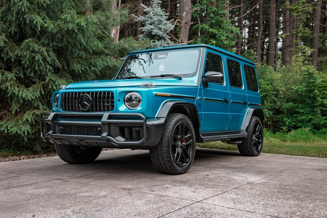 Teal mercedes-benz g-wagon parked on driveway