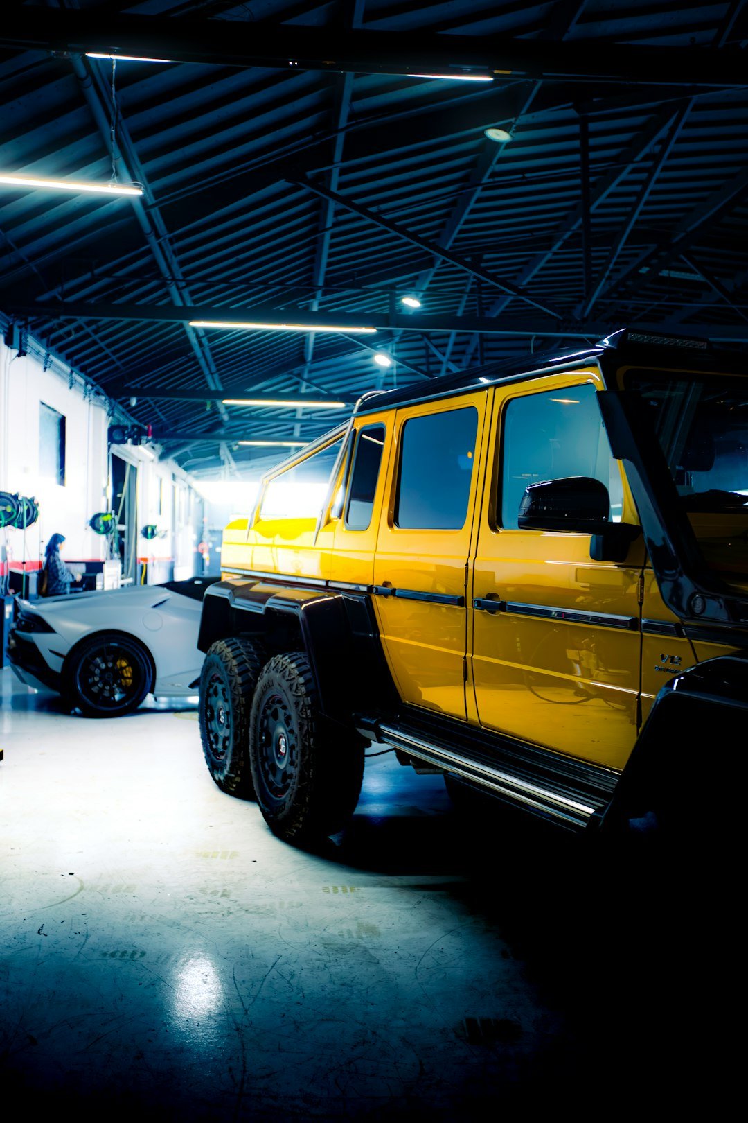 Yellow six-wheeled vehicle parked in garage.