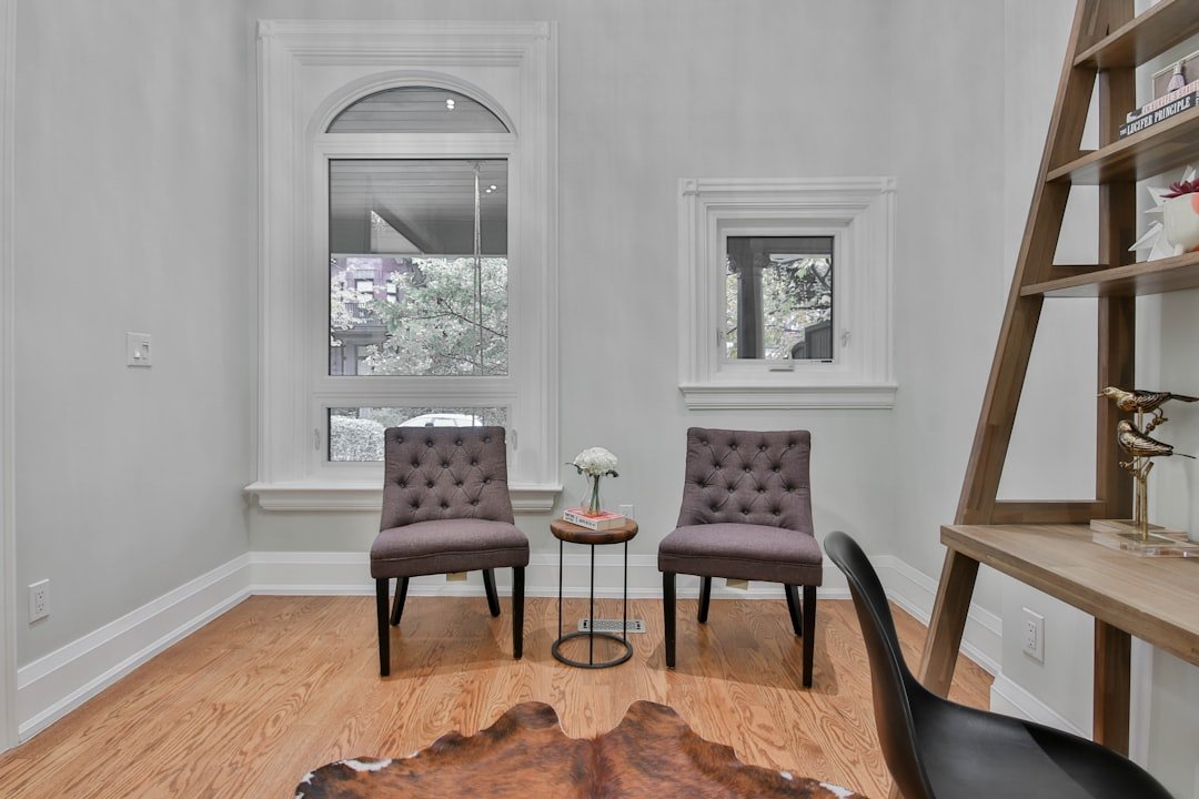 a living room with two chairs and a table