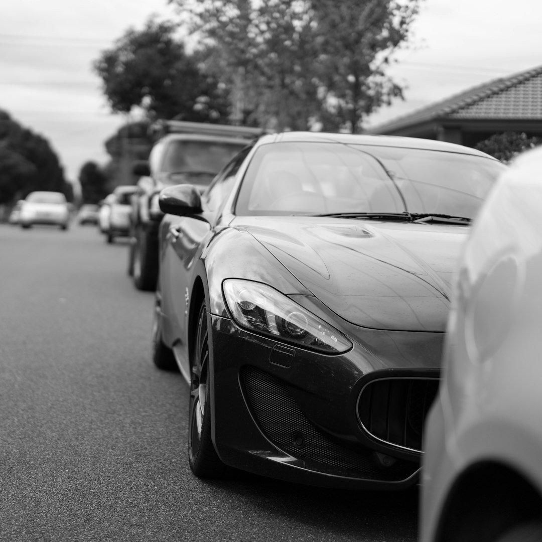 Line of luxury cars parked on street