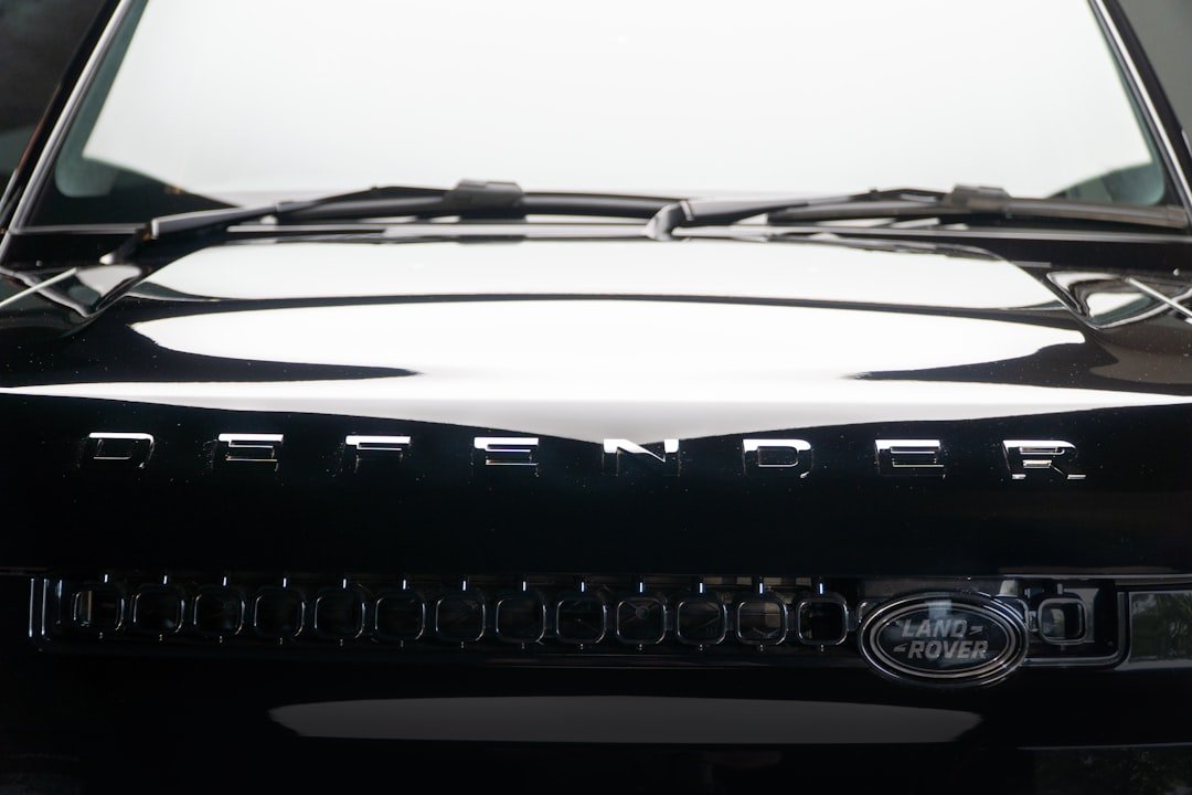 The front of a black land rover defender.