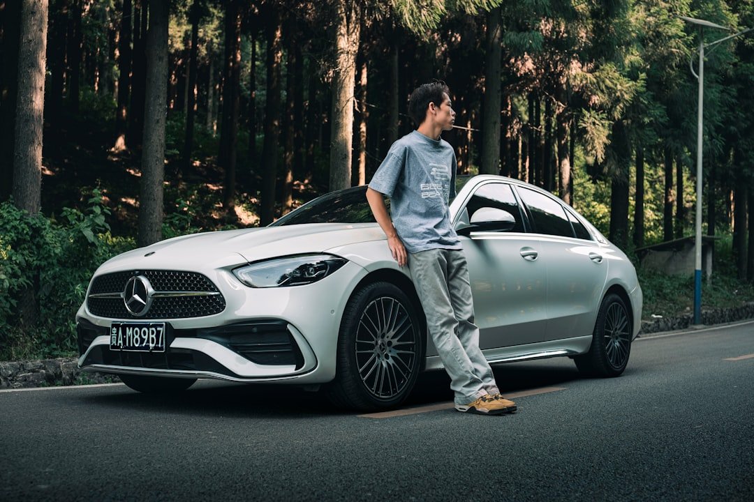 A man standing on the hood of a car