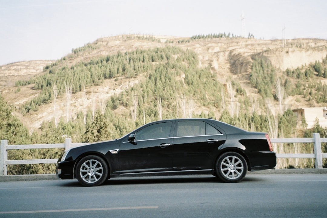 black coupe on gray asphalt road during daytime