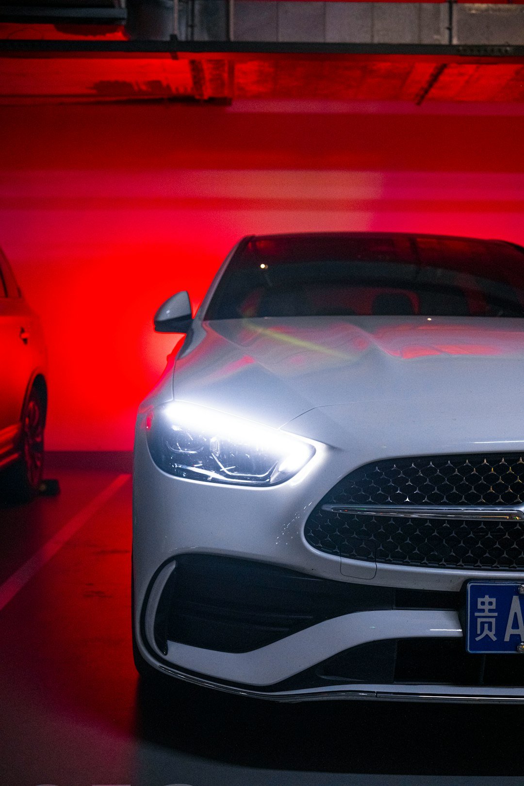 A silver car parked in a parking garage