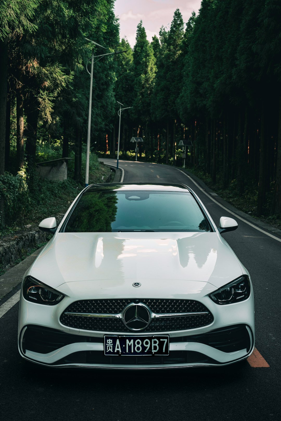 A white car parked on the side of a road