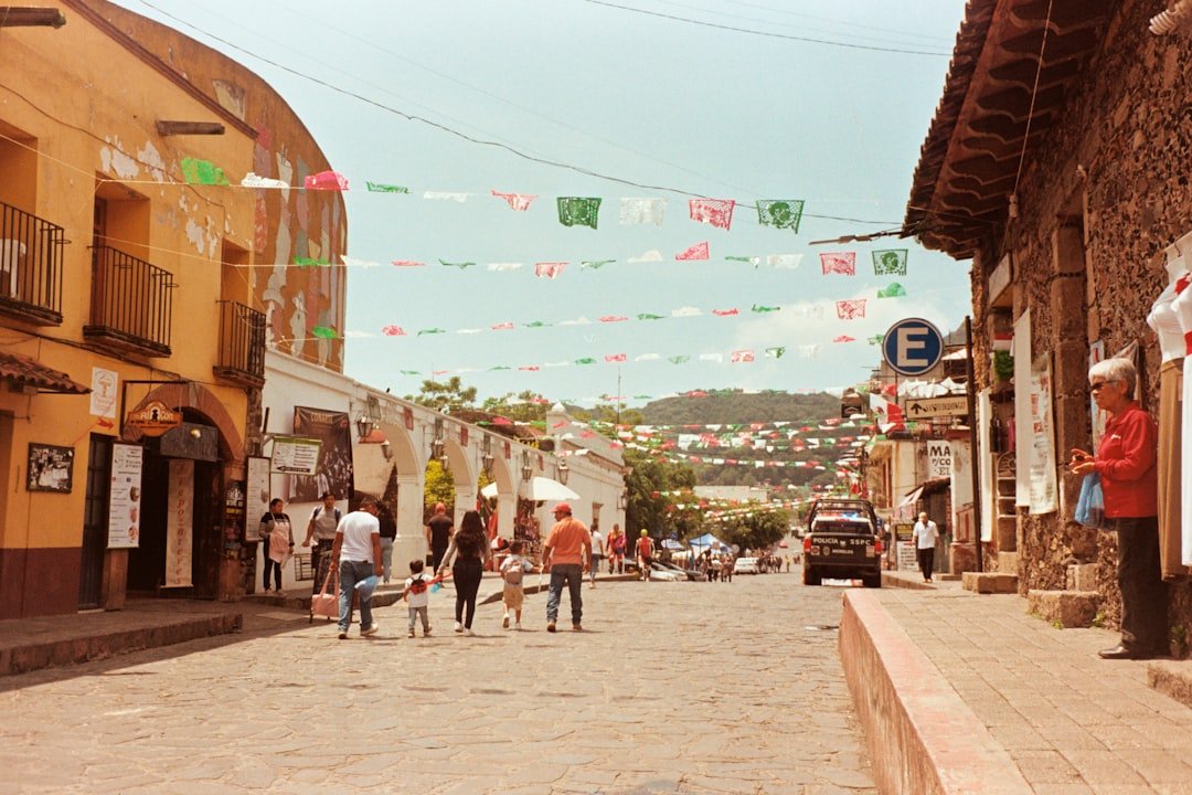 People walking down a street decorated with flags