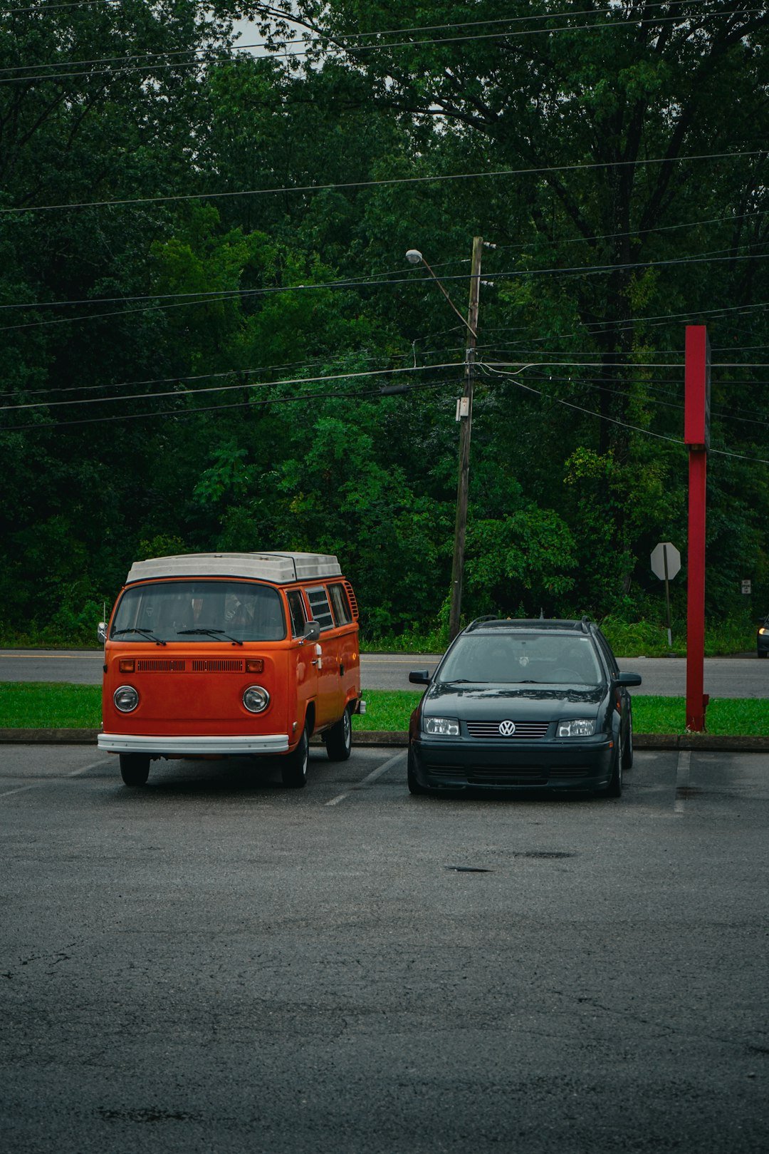 two cars parked next to each other in a parking lot