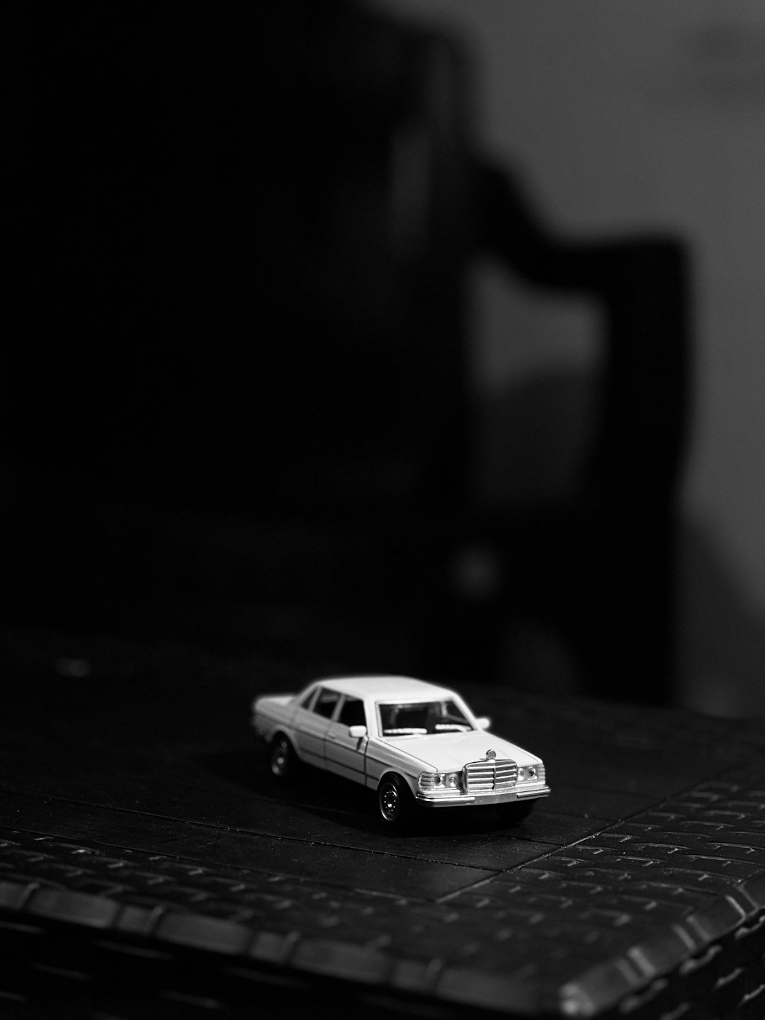 A small toy car on a dark surface.