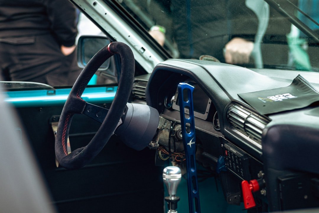A modified car interior with a custom steering wheel.