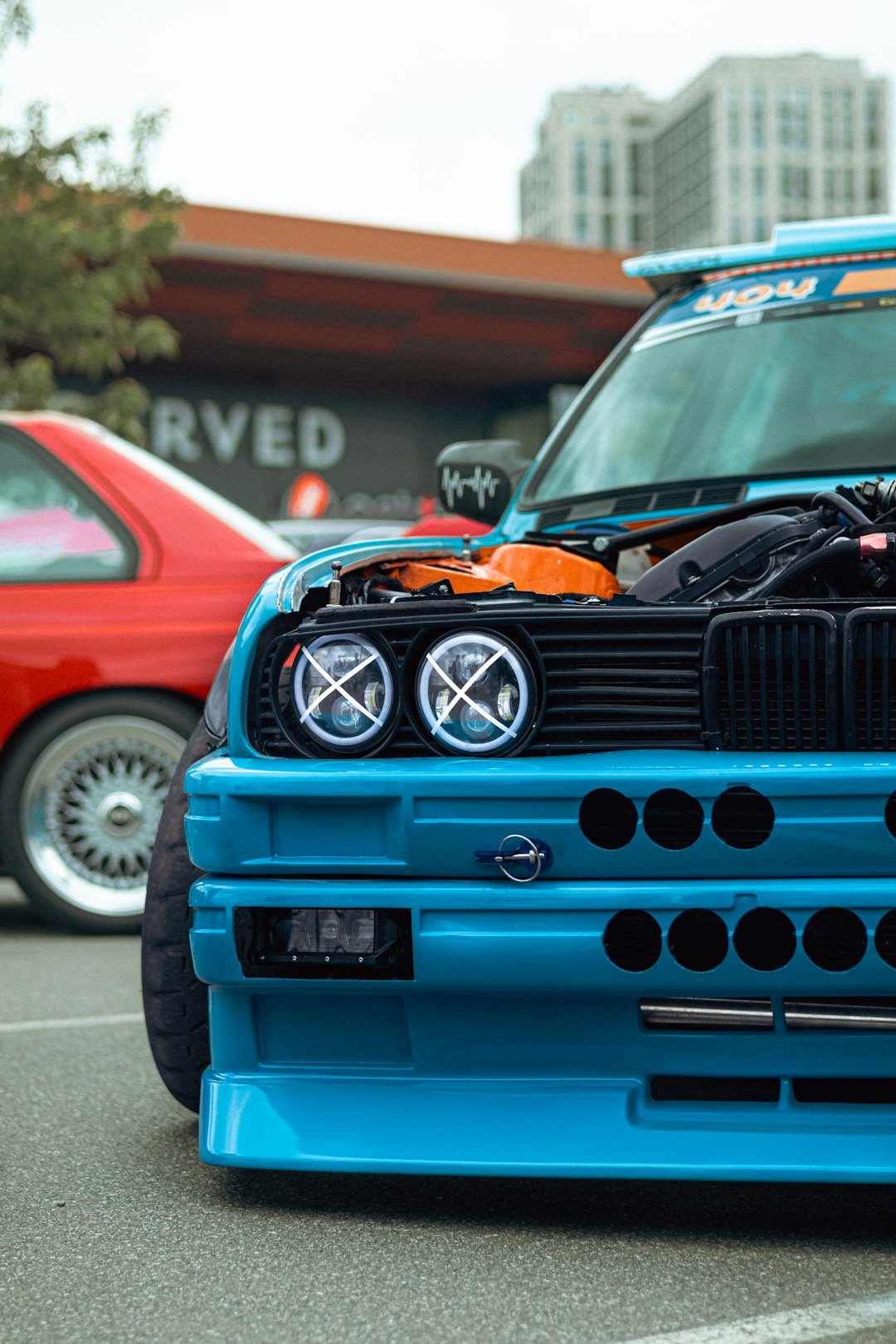 A blue modified car is showcased.