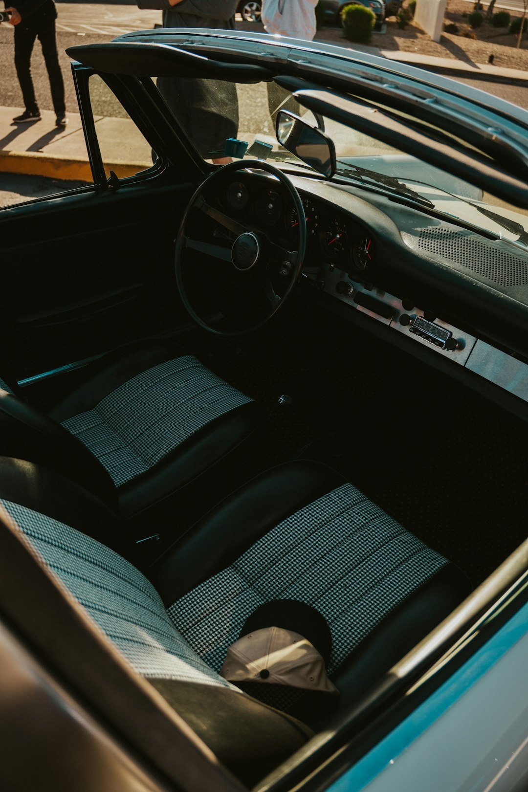 Inside the classic car: steering wheel, seats, and dashboard.