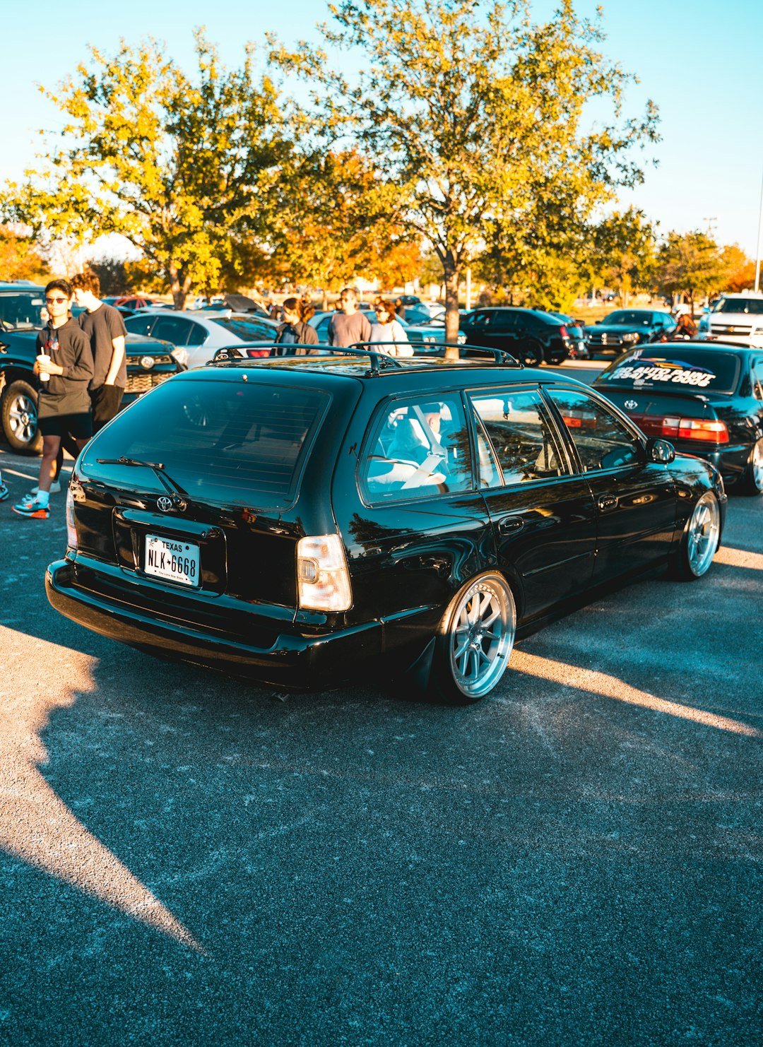 a black car parked in a parking lot