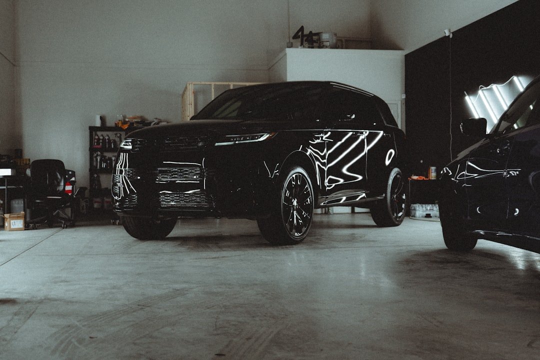 A couple of cars parked in a garage